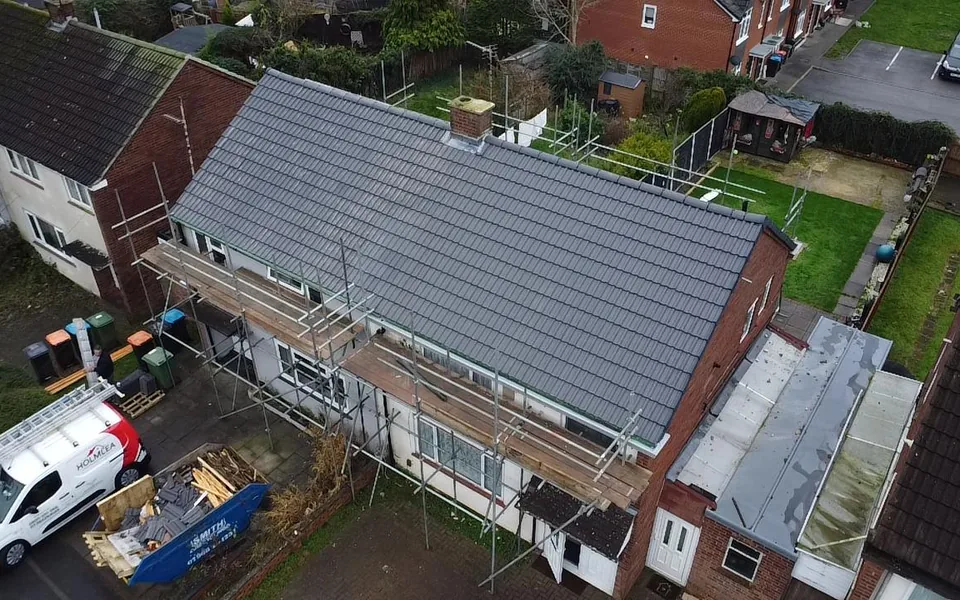 New natural slate roof on a semi-detached house, aerial view with the Holmlea van in the street